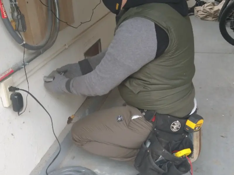 Electrician performing outlet wiring in a Bellair-Meadowbrook Terrace garage
