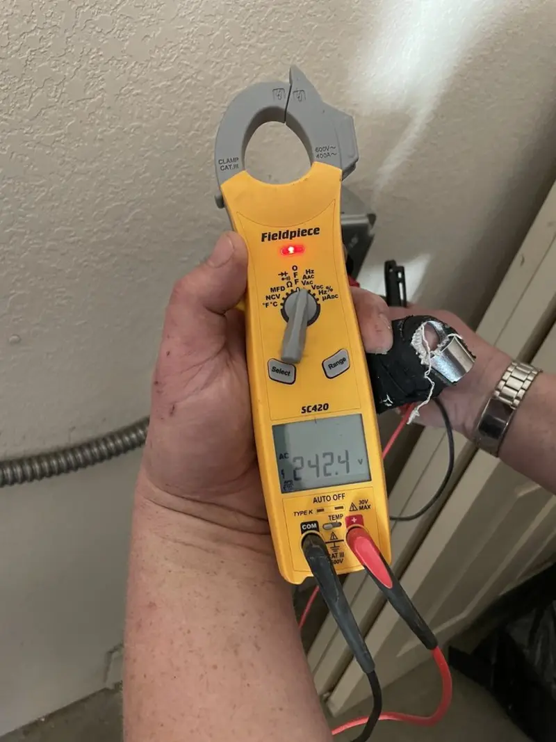 Voltage testing with clamp meter during Recessed Lighting Installation in Bellair-Meadowbrook Terrace